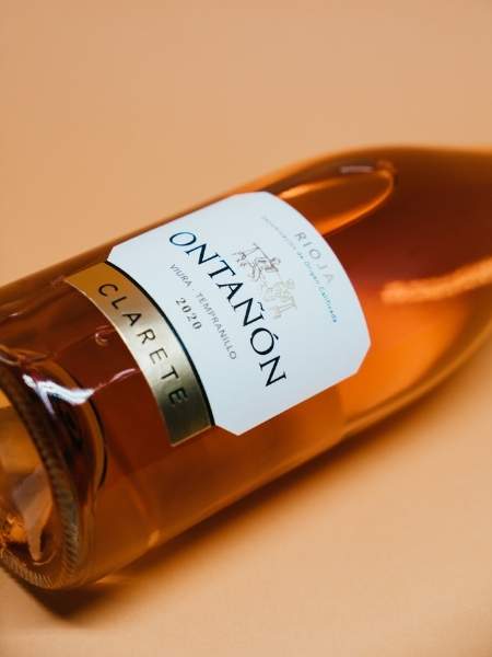 Front White Label Details of the Bottle on Beige Background