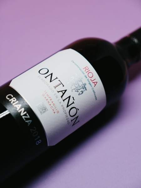 Front Label Details of the Bottle on Purple Background