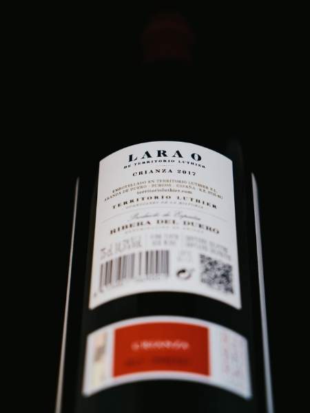 Back Label With Description of Bottle on Black Background